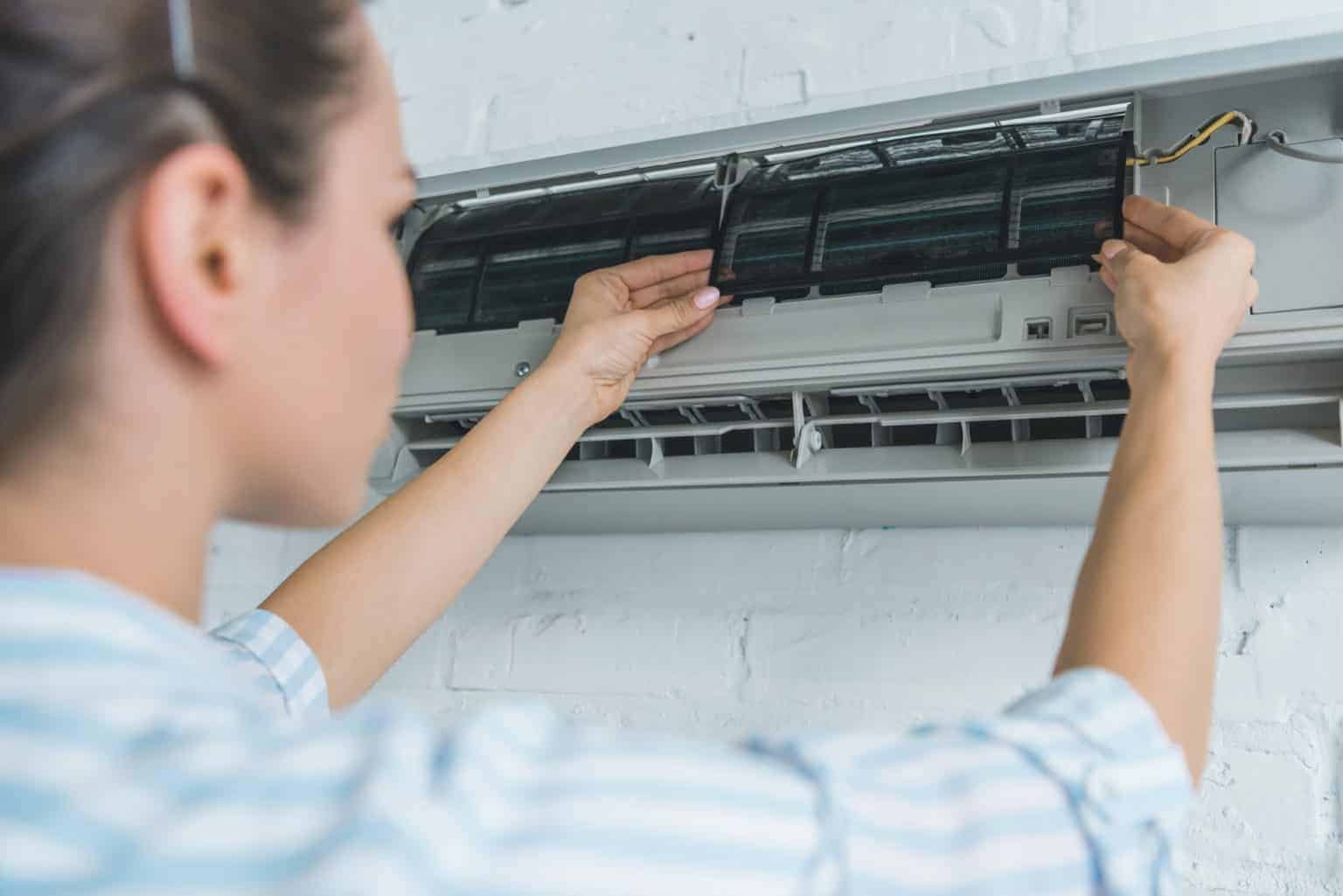 women fixing the air conditioner