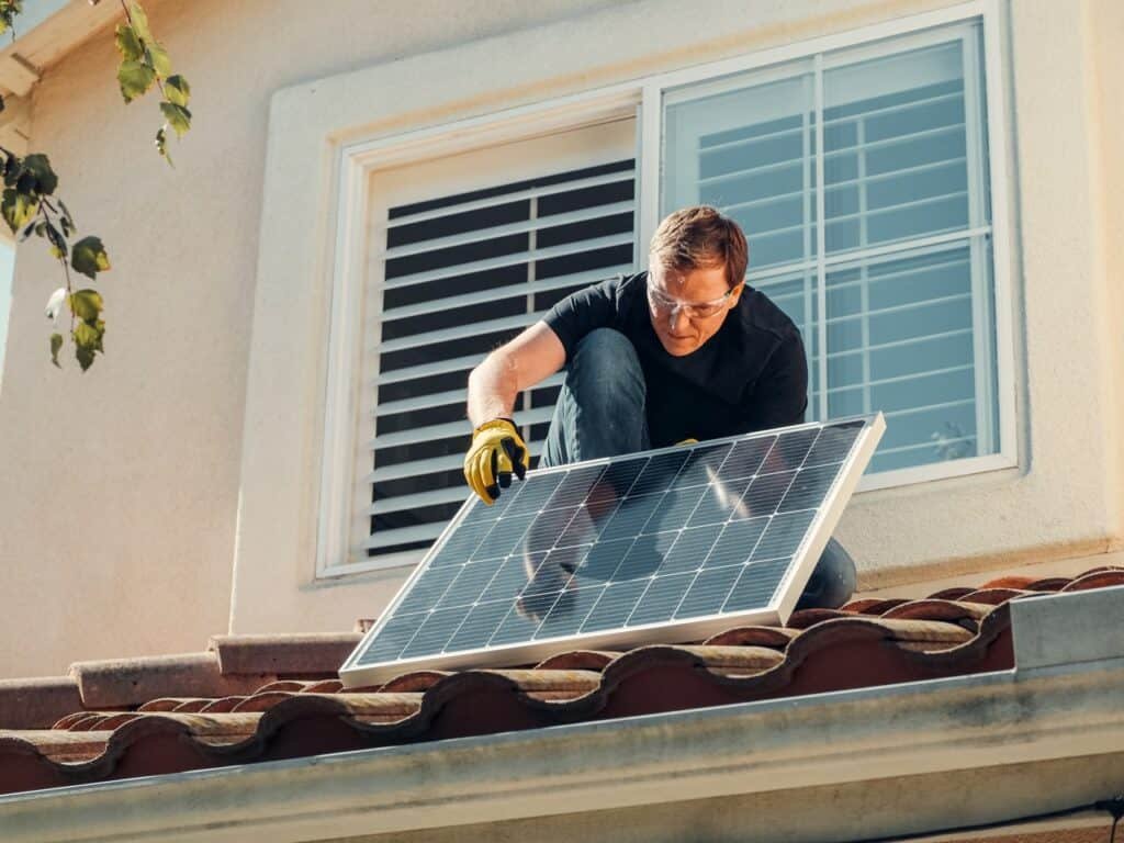 man installing solar panel