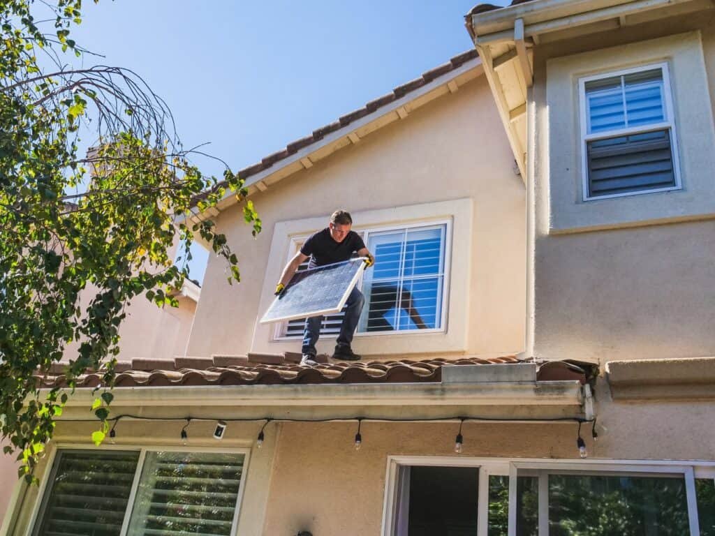 man installling solar panels