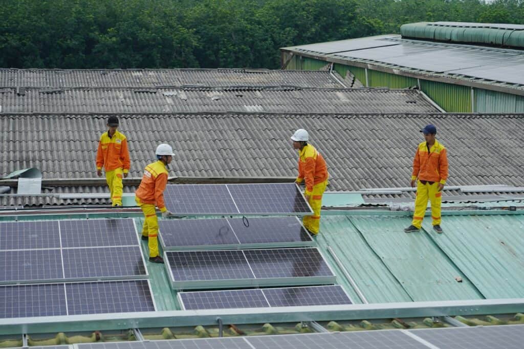 solar panel installers on the roof