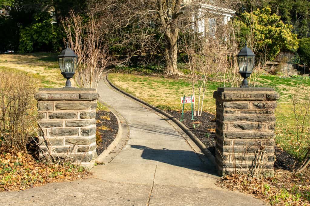 Two Cobblestone Pillars With a Paved Path Running Between Them