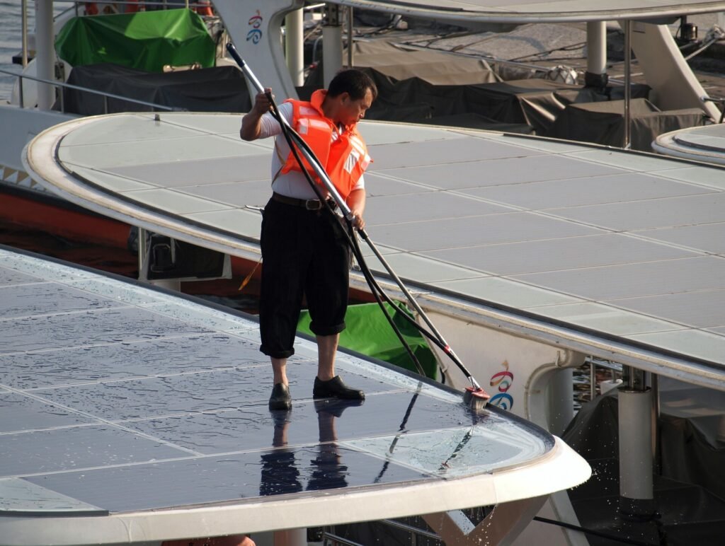 Man cleaning solar panels